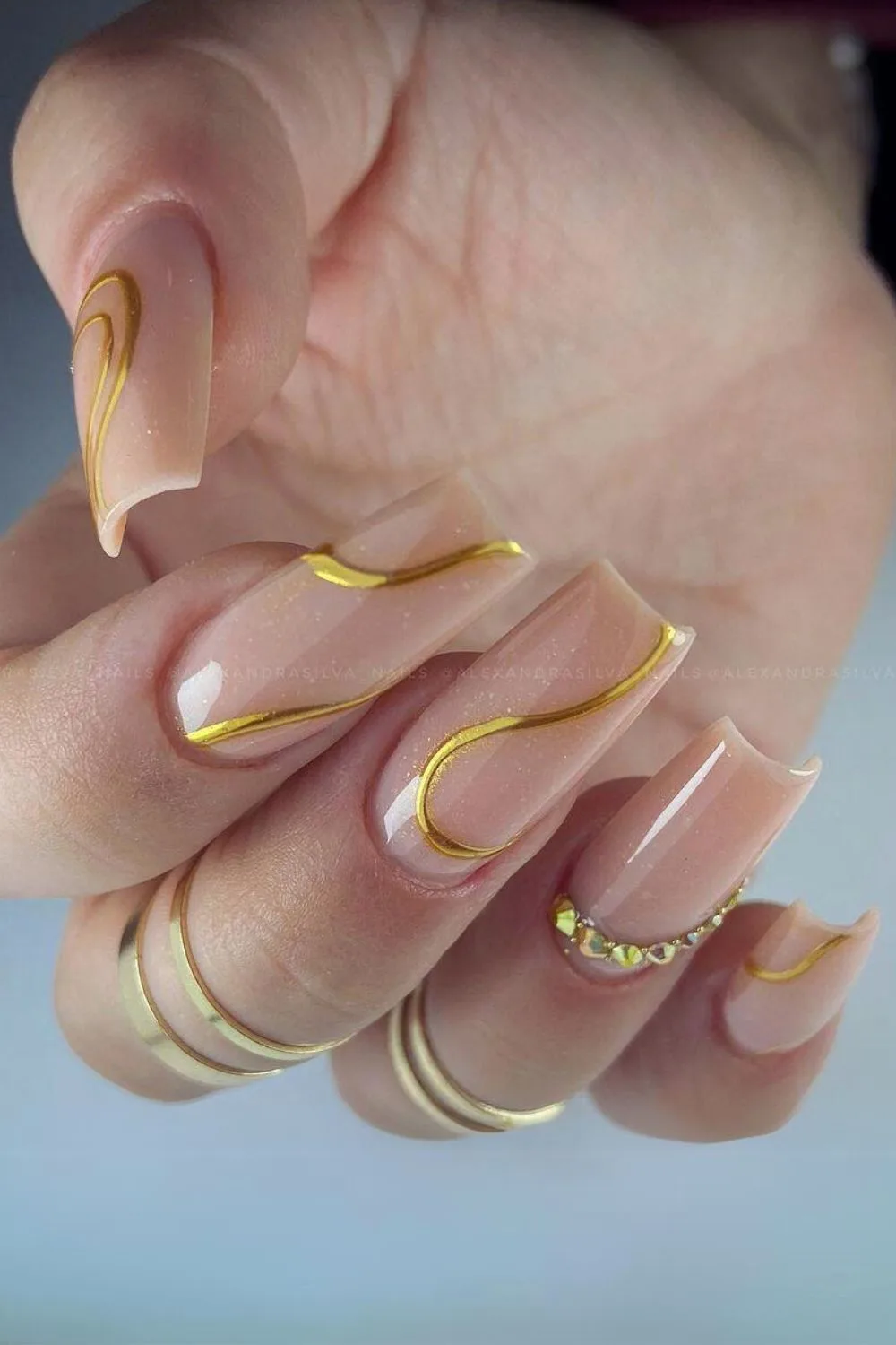 Nude nails with gold swirls