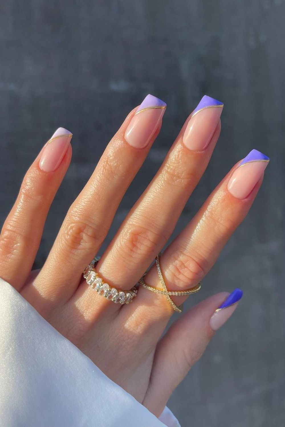 Nude nails with side tips in different shades of purple