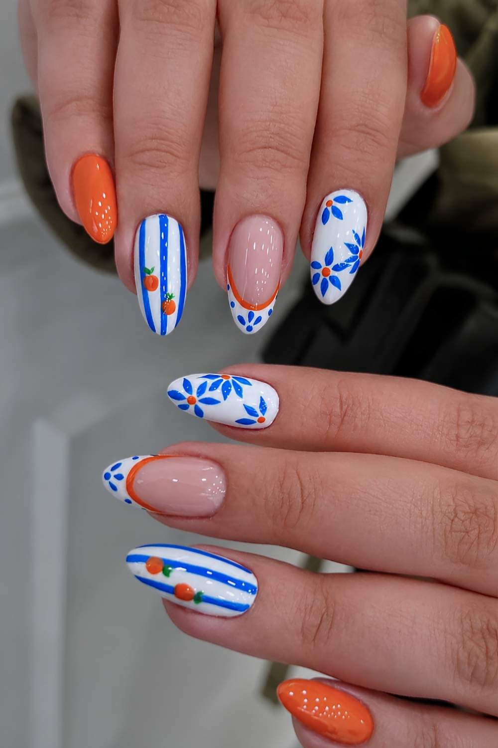 Orange and blue nails with stripe and fruit art