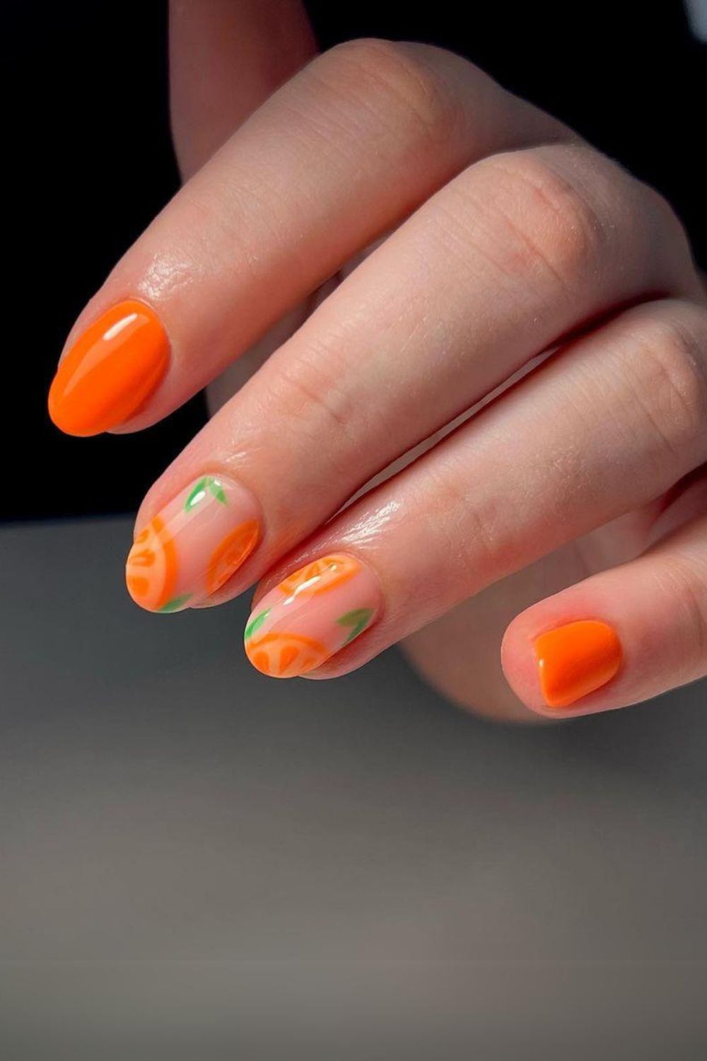 Orange nails with fruit design