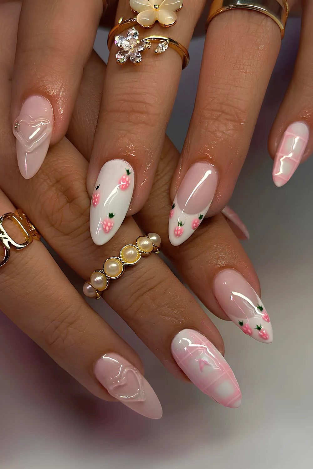 Pink and white nails with strawberries and hearts
