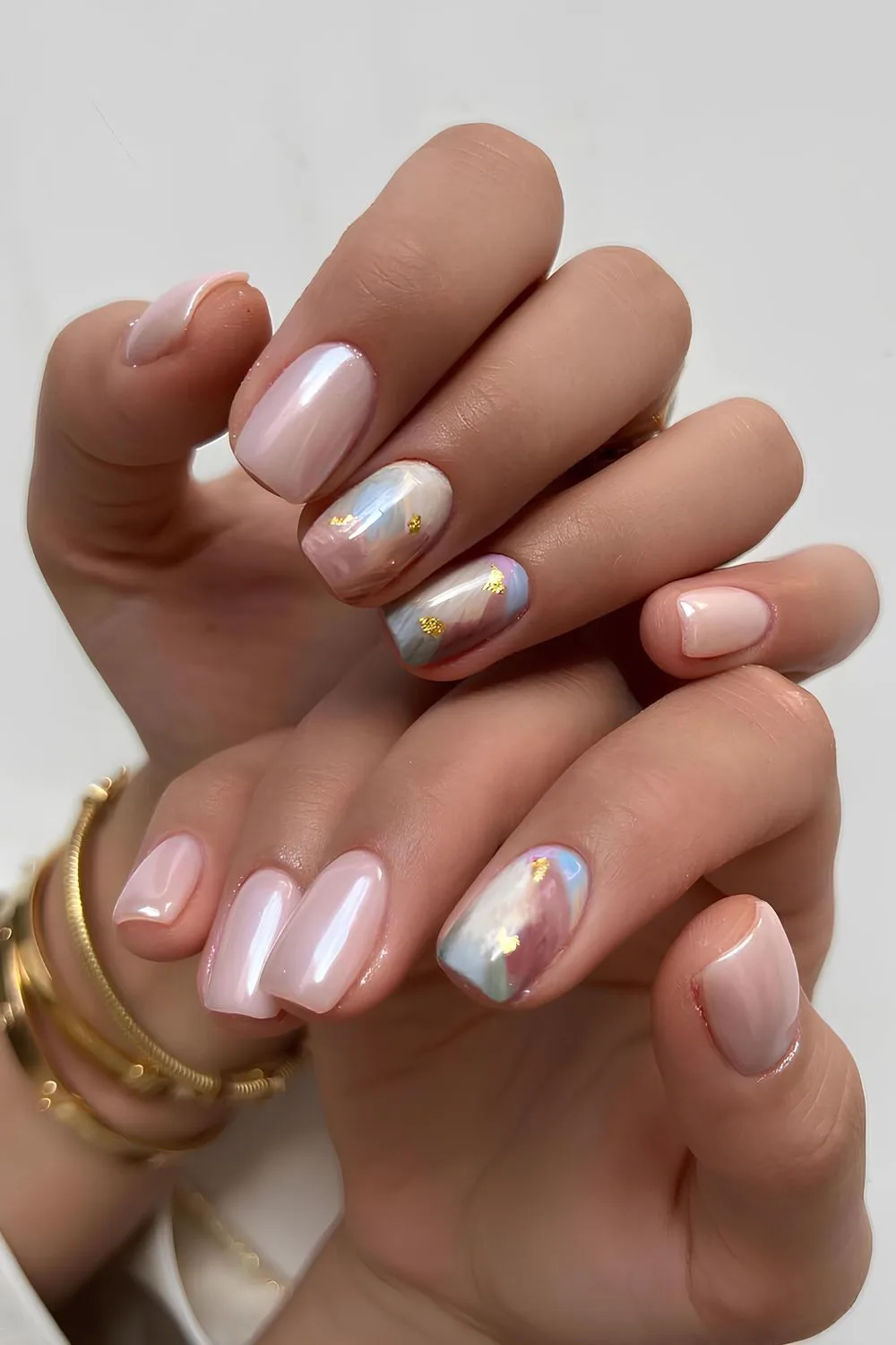 Pink chrome nails with colorful marble accent