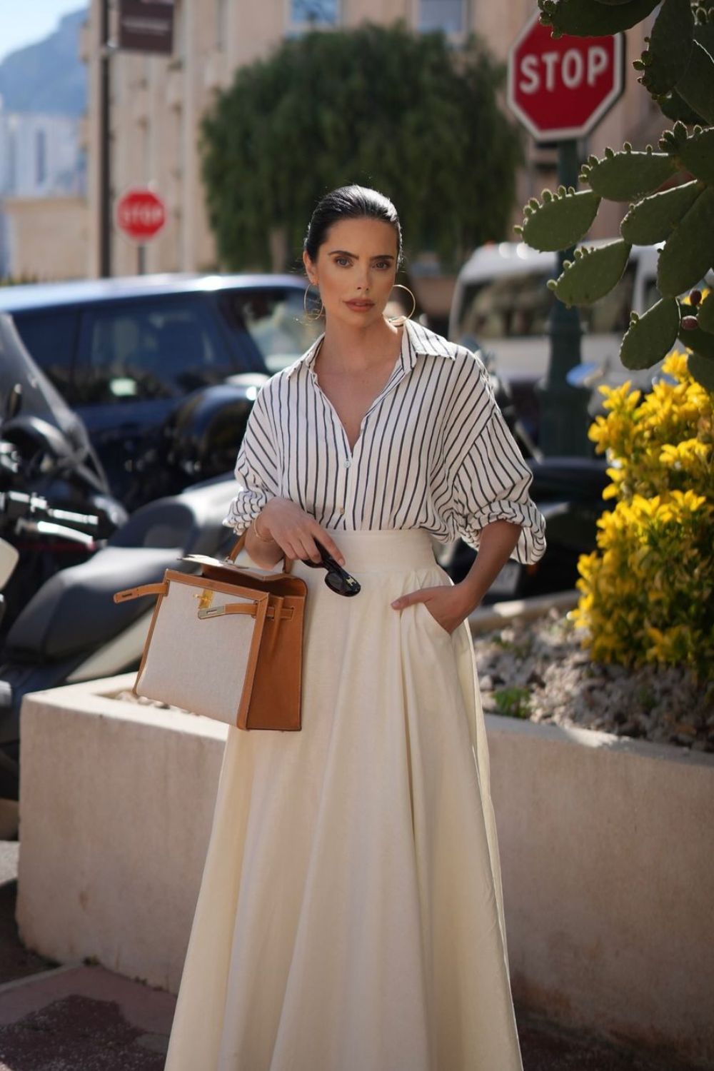 Poised woman with a structured bag