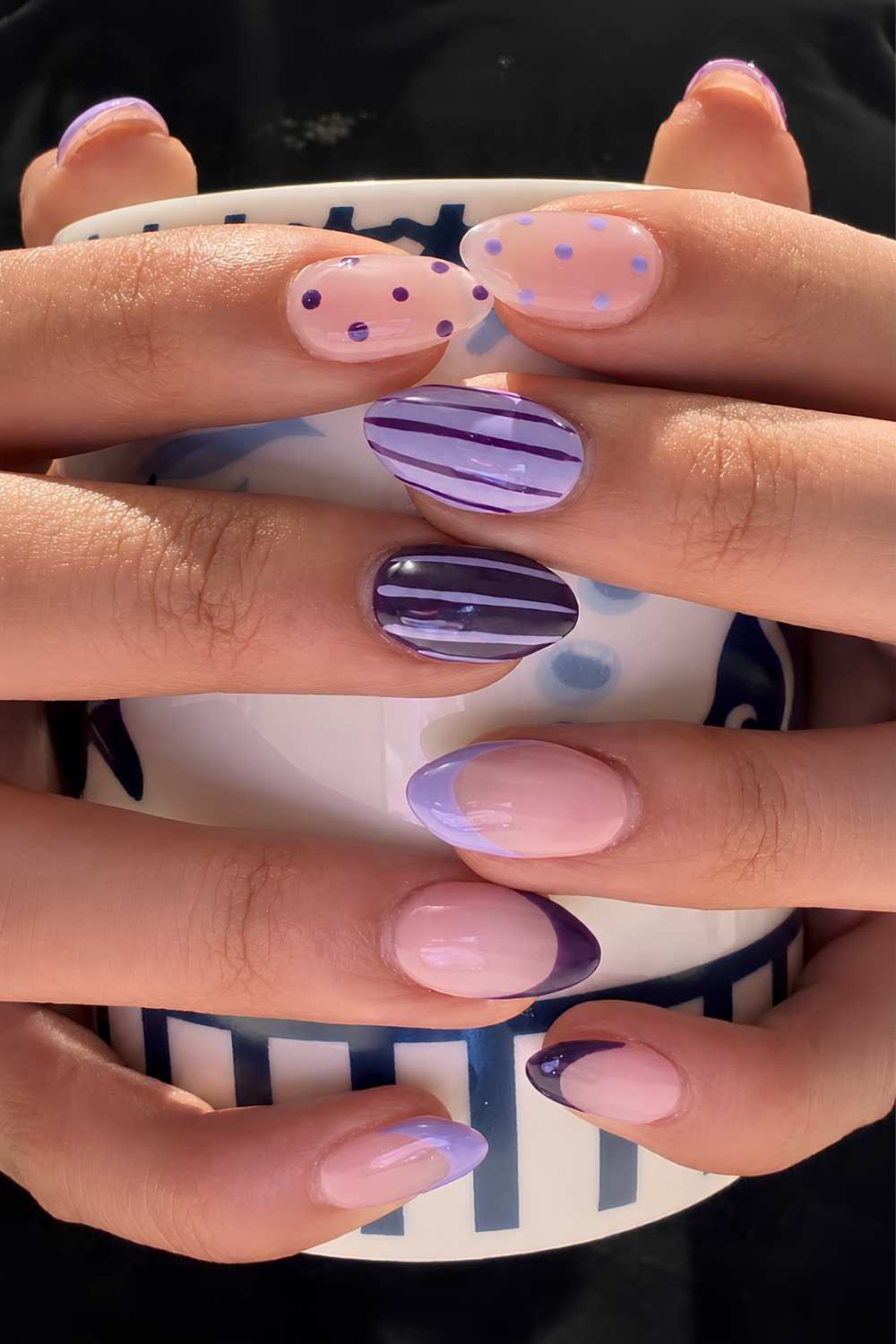 Purple nails with stripes and polka dots