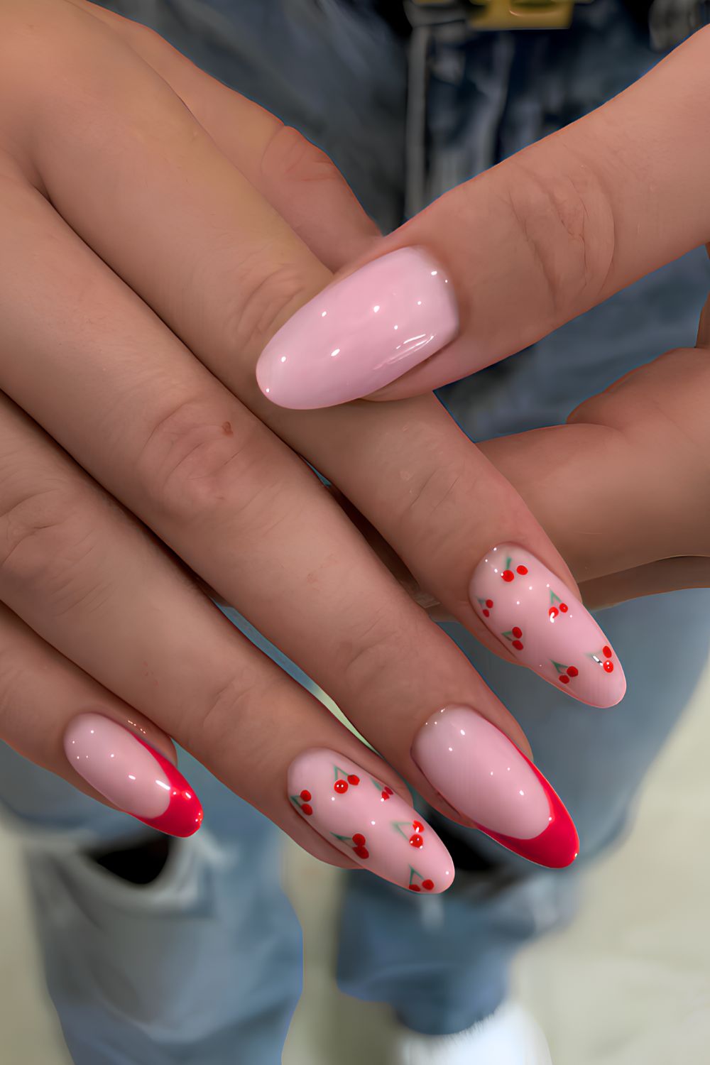Red French tip nails with accent cherry art