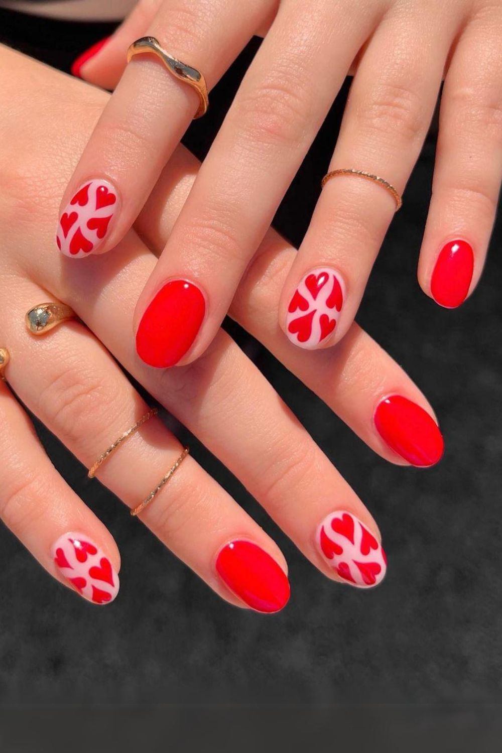 Red nails with heart accents