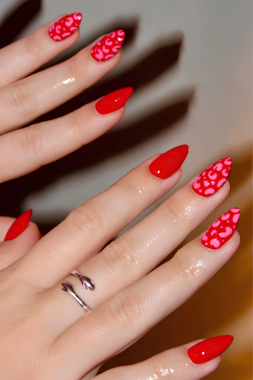 Red nails with pink cheetah print