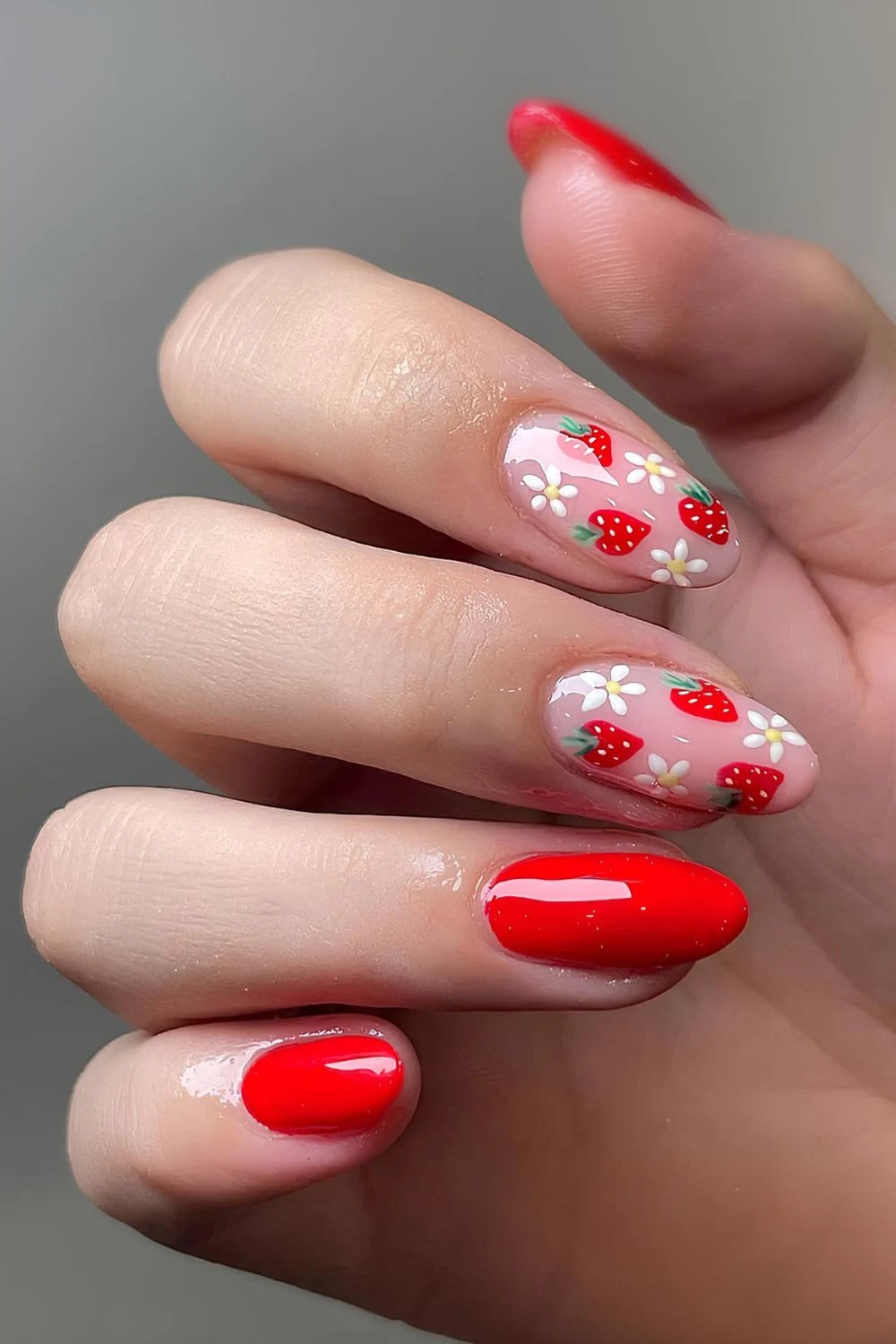 Red nails with strawberries and flowers