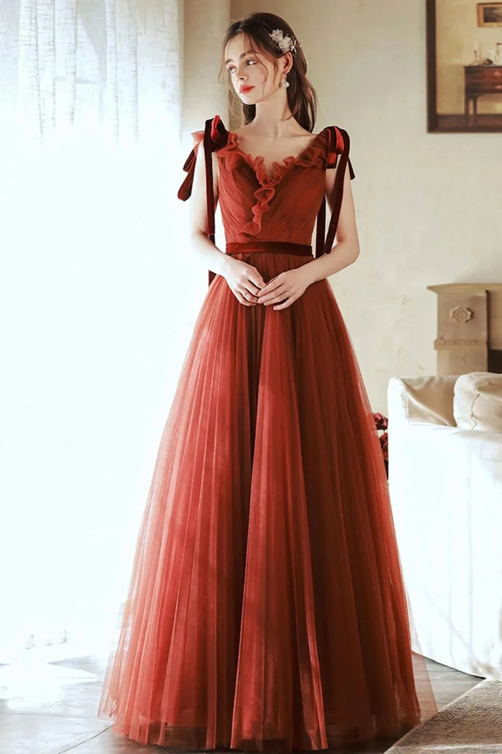 Rust tulle gown with ruffled straps