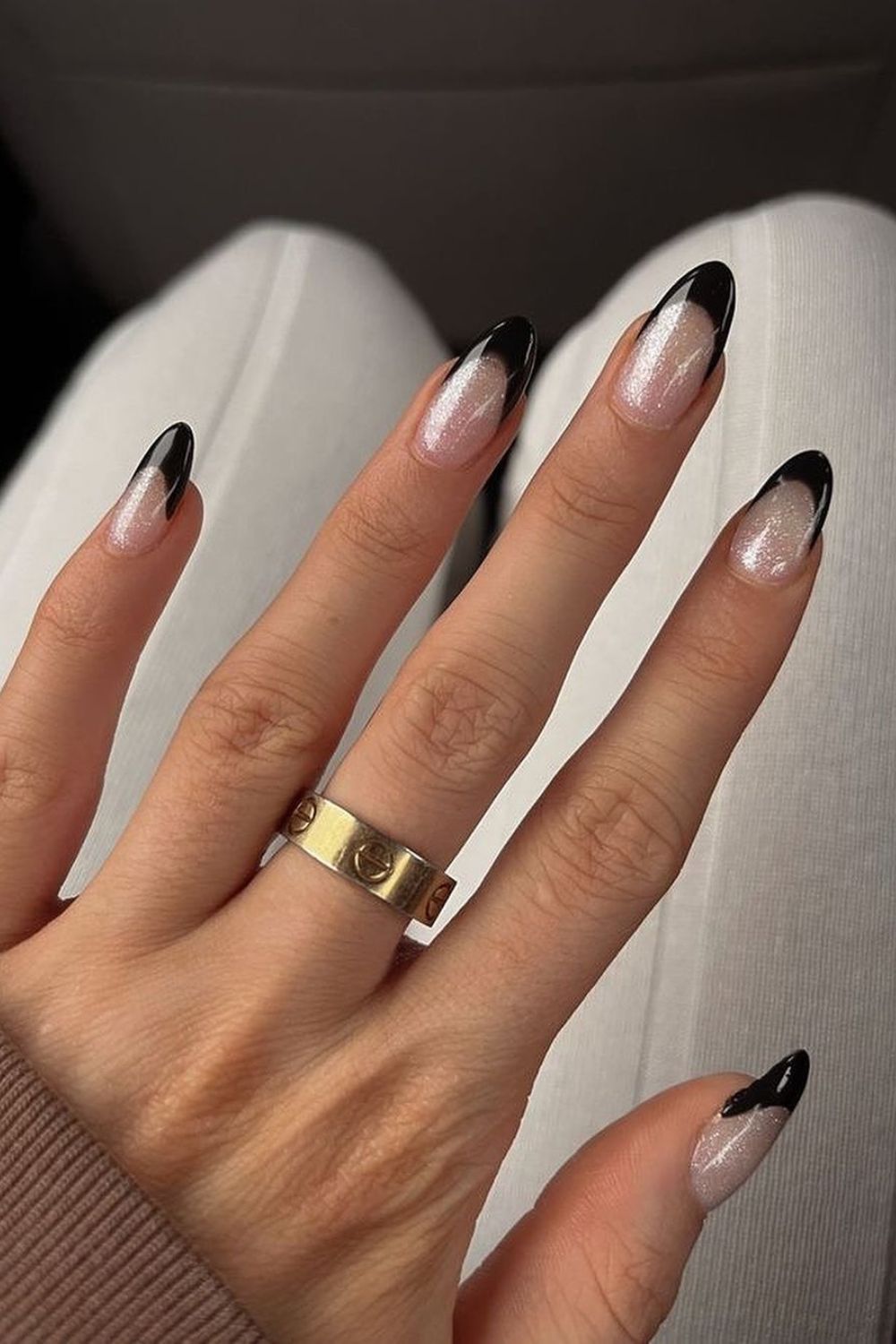 Shimmery white nails with black tips