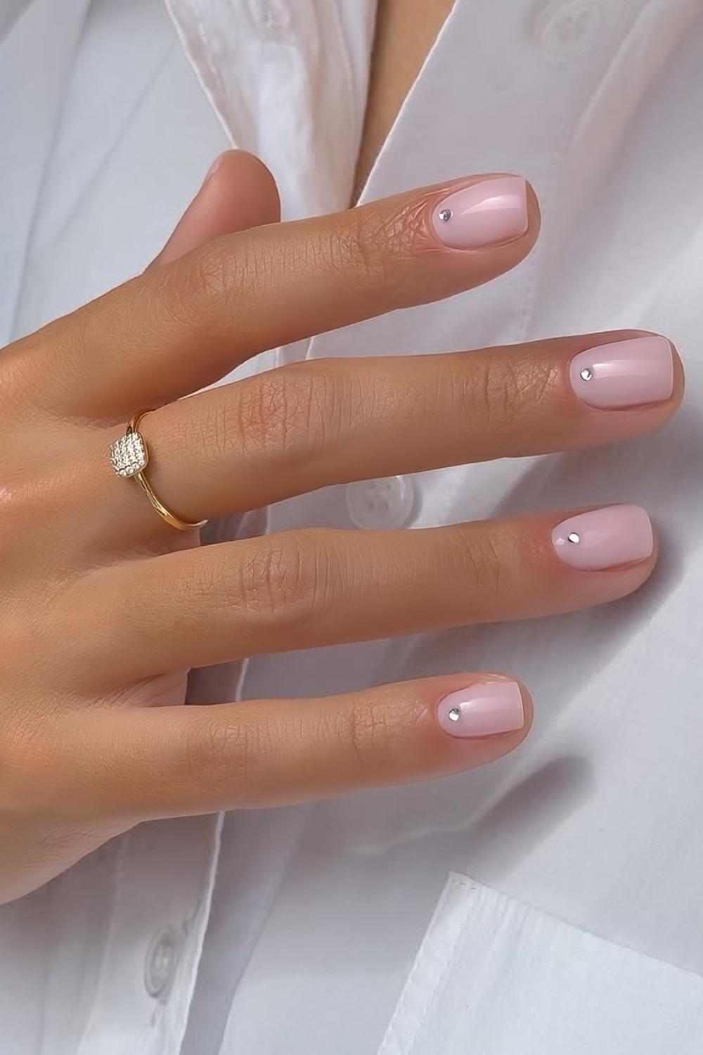 Short milky pink nails with cuticle rhinestones