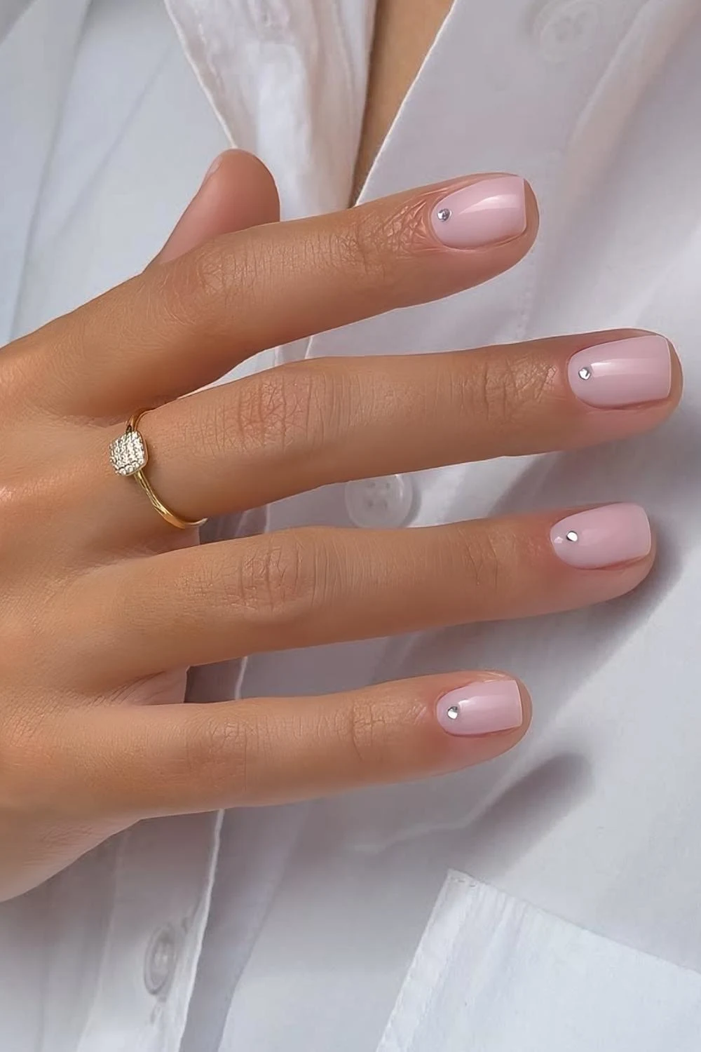 Short milky pink nails with cuticle rhinestones
