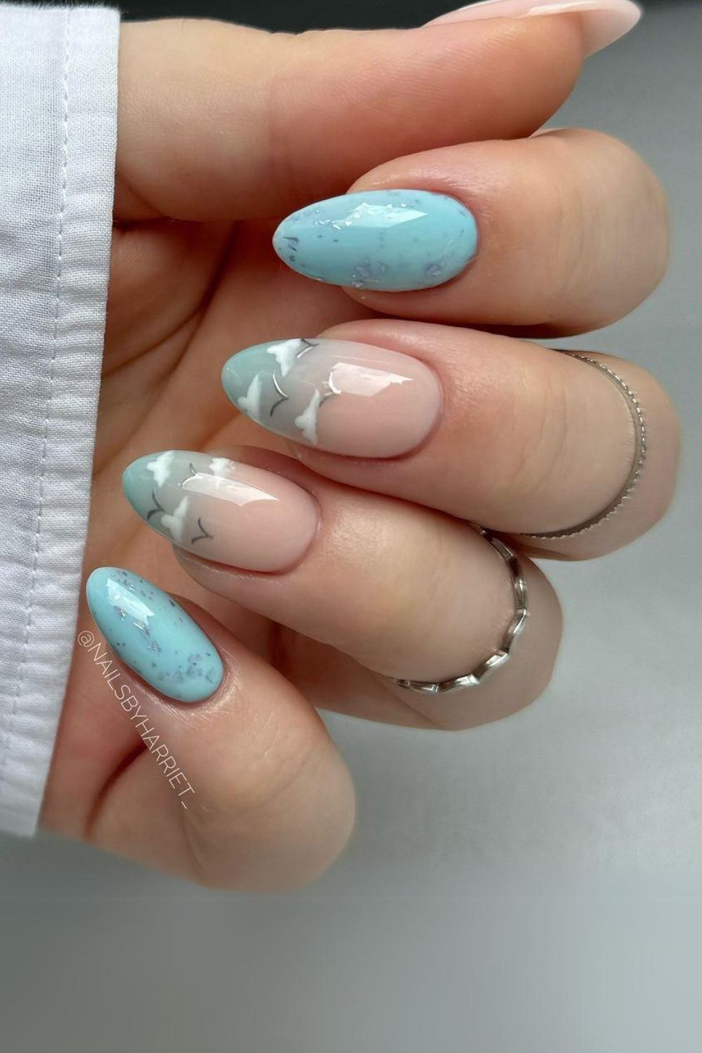 Sky blue nails with clouds and birds