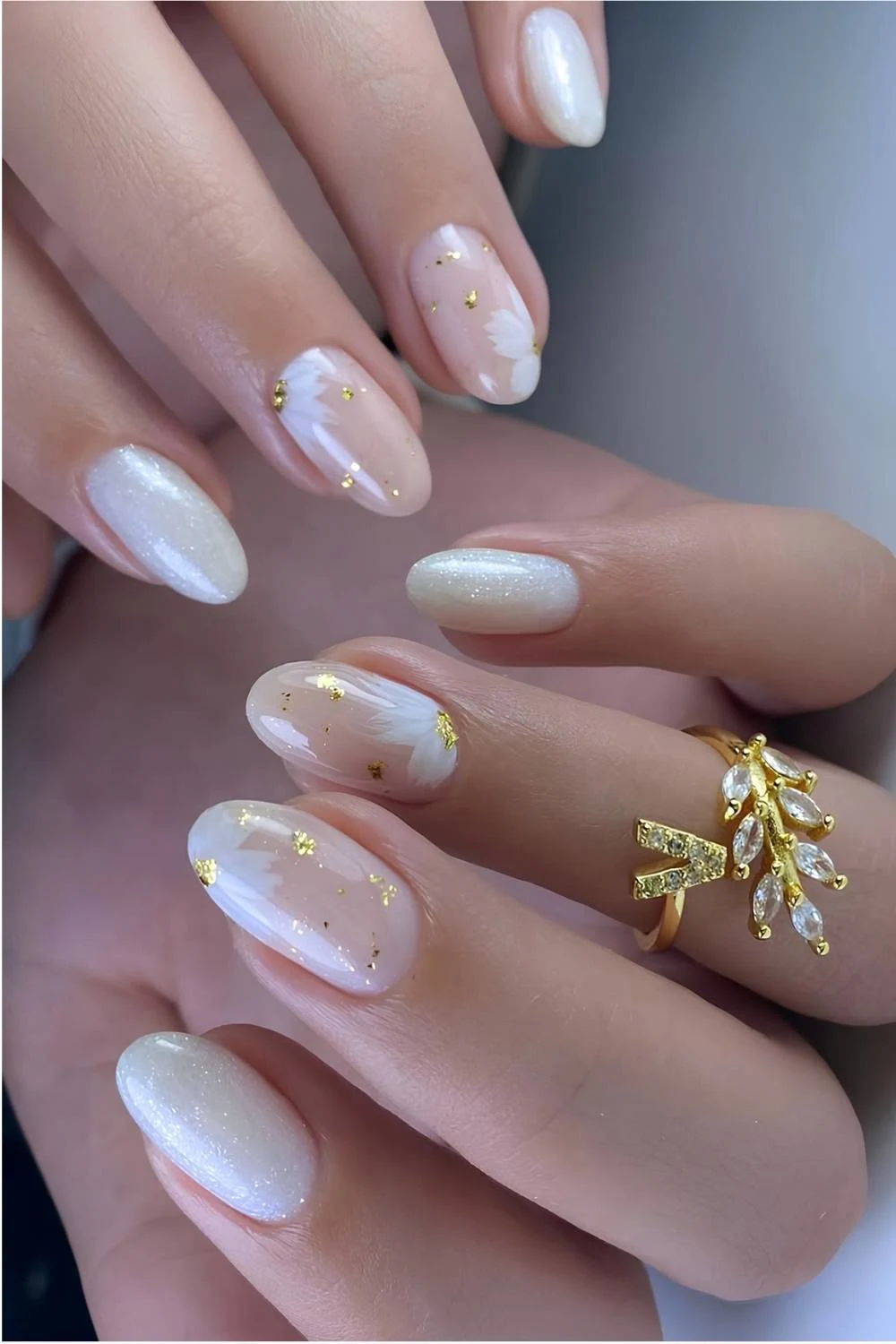 Sparkly and milky white nails with flowers and gold flakes