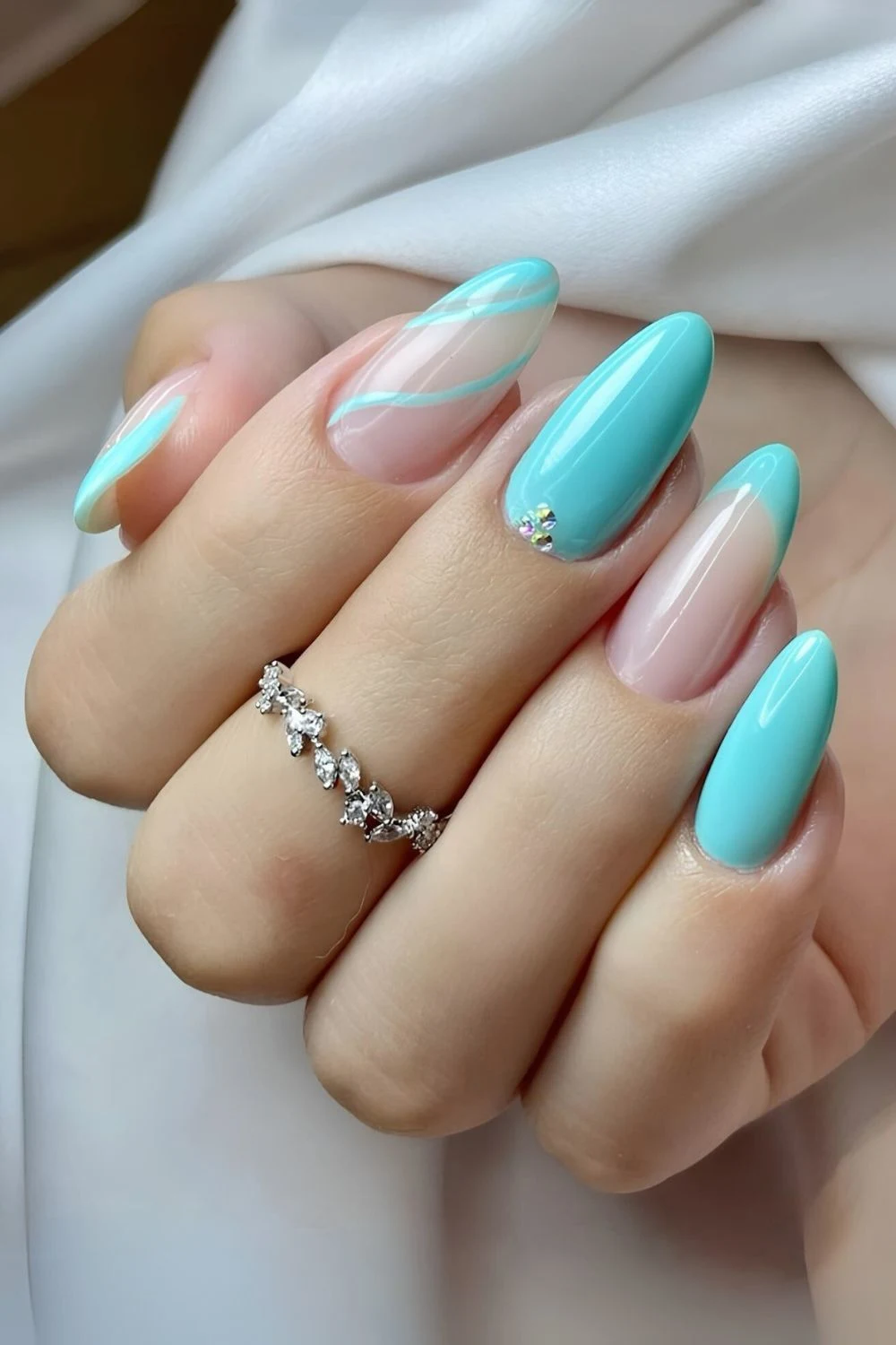 Tiffany blue mani with swirls and gems