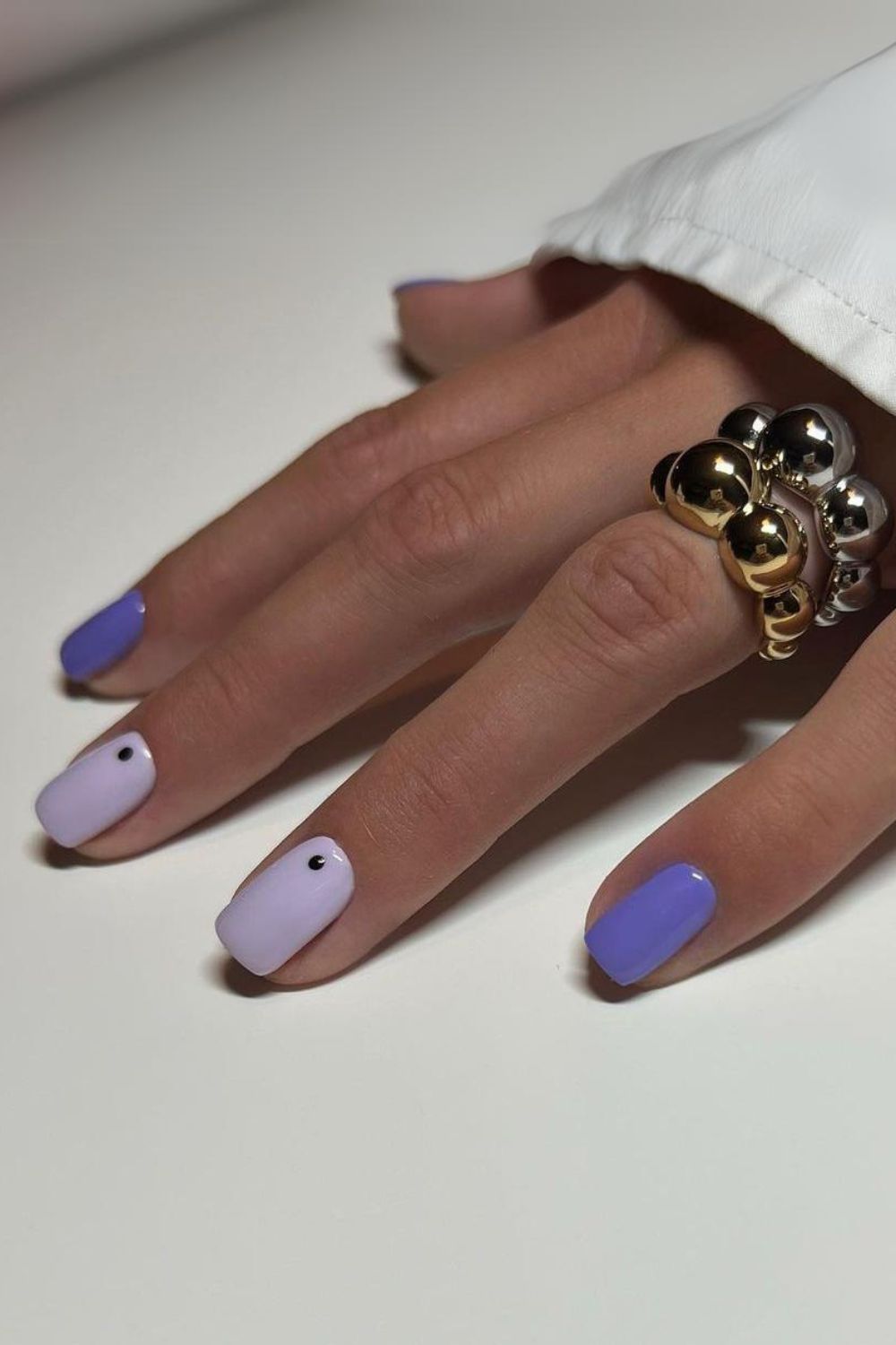 Two-shade purple nails with dot accents