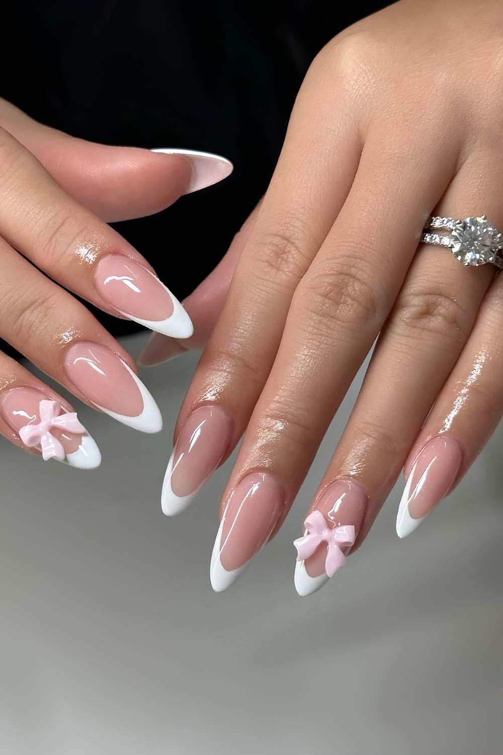 White French Tip nails with pink 3d bows