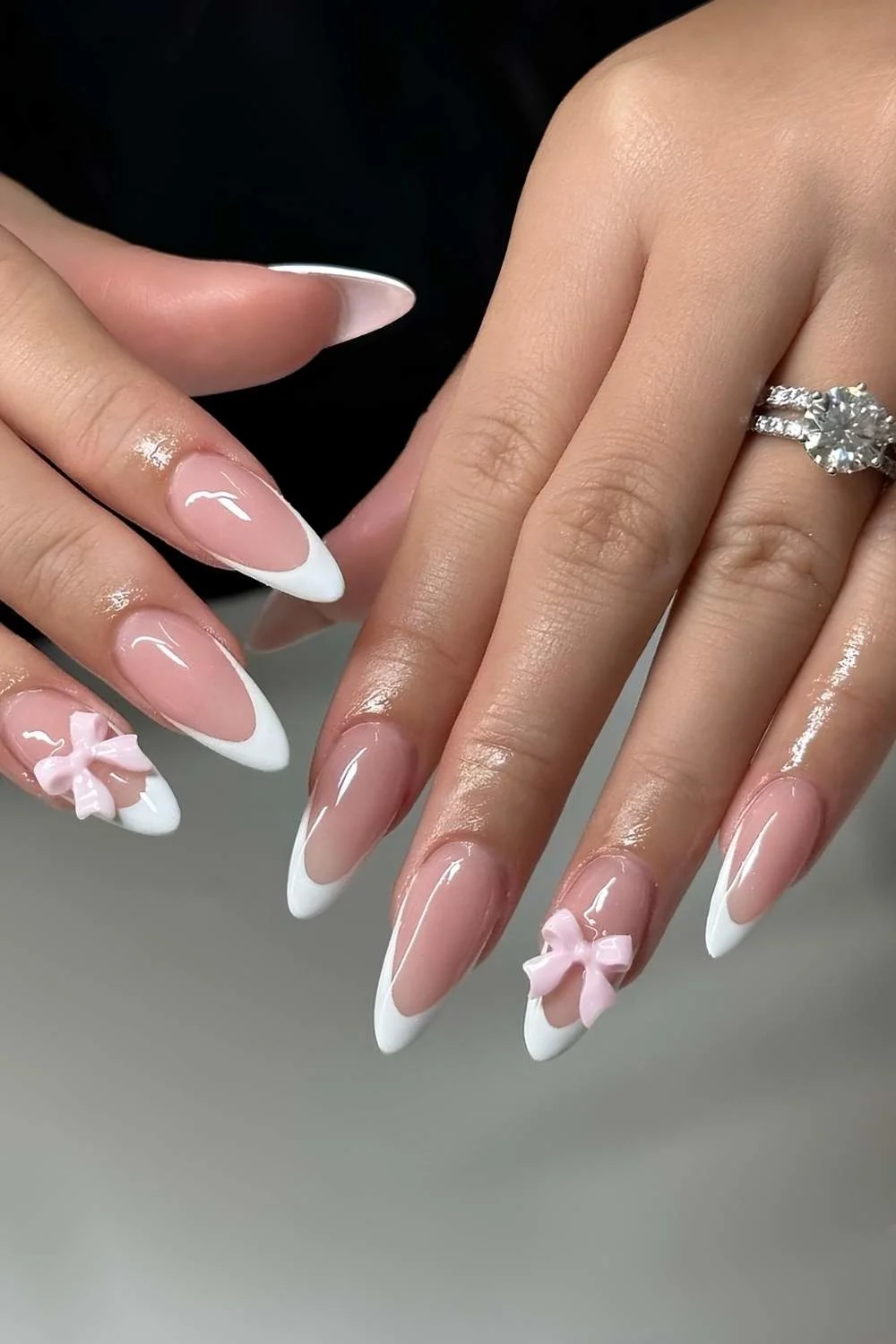 White French Tip nails with pink 3d bows
