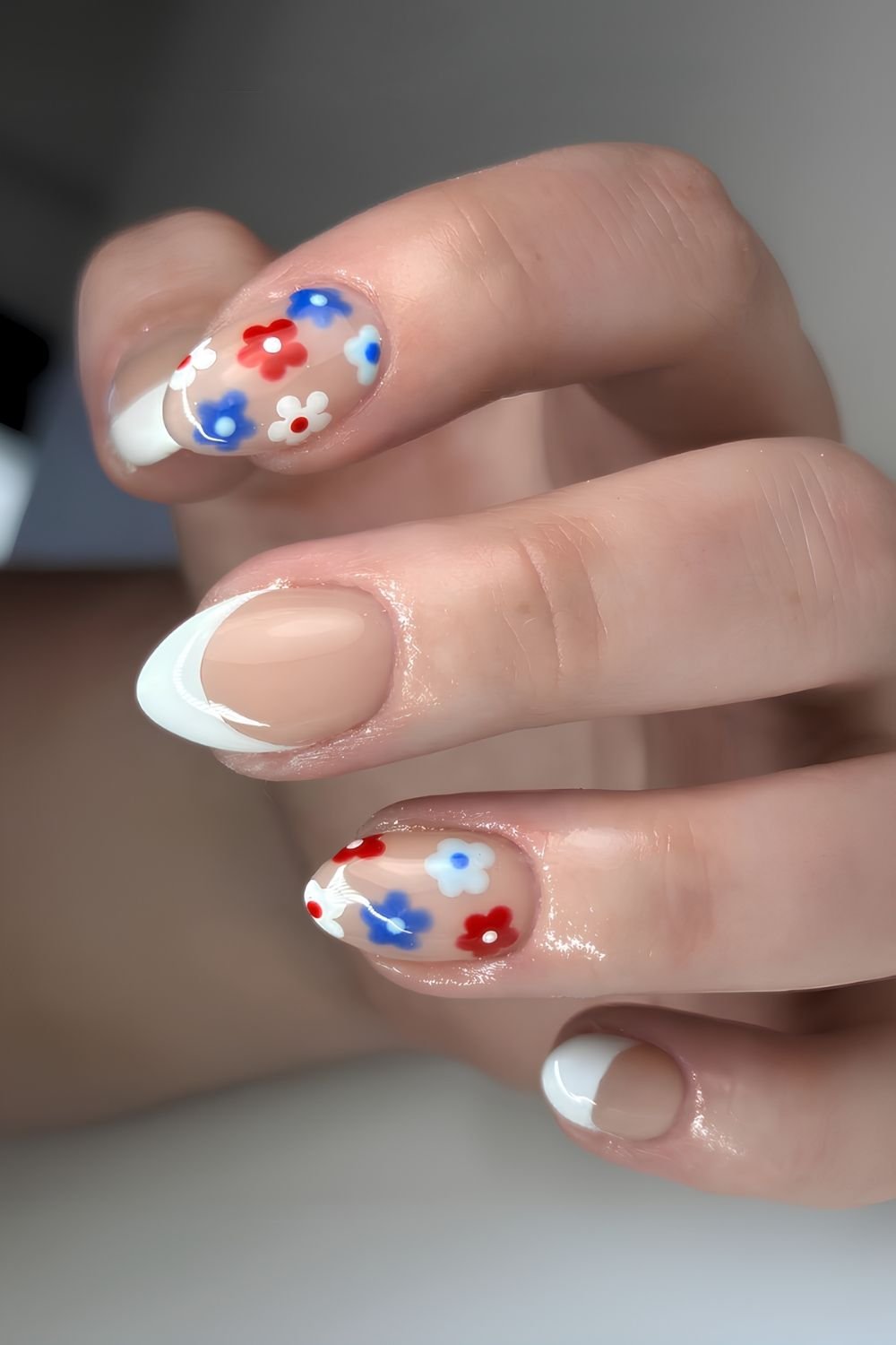 White French tip mani with red and blue flowers