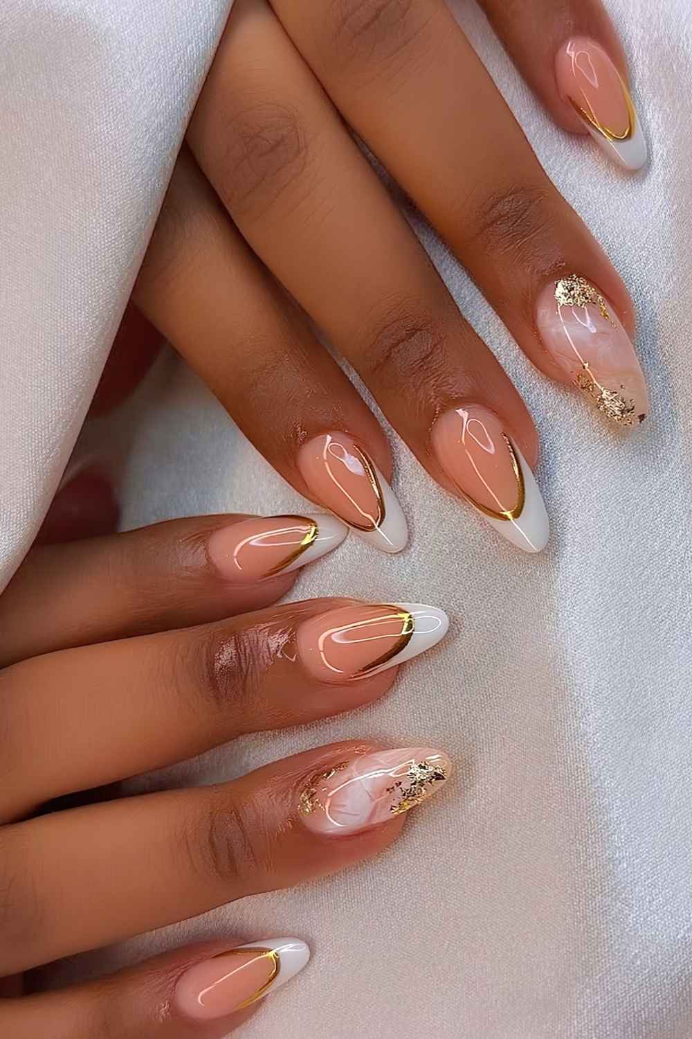 White French tips with gold outlines and marble accents