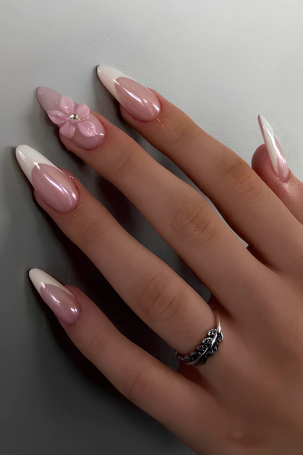White chrome French nails with textured flowers