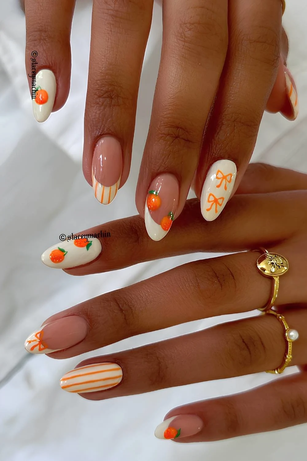 White nails with orange stripe and fruit details