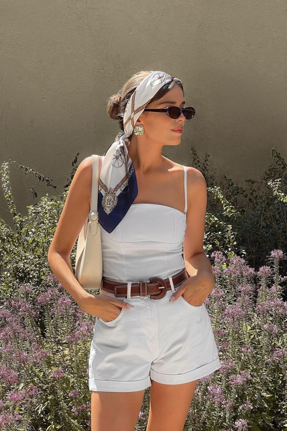 White top with belted shorts and a headscarf