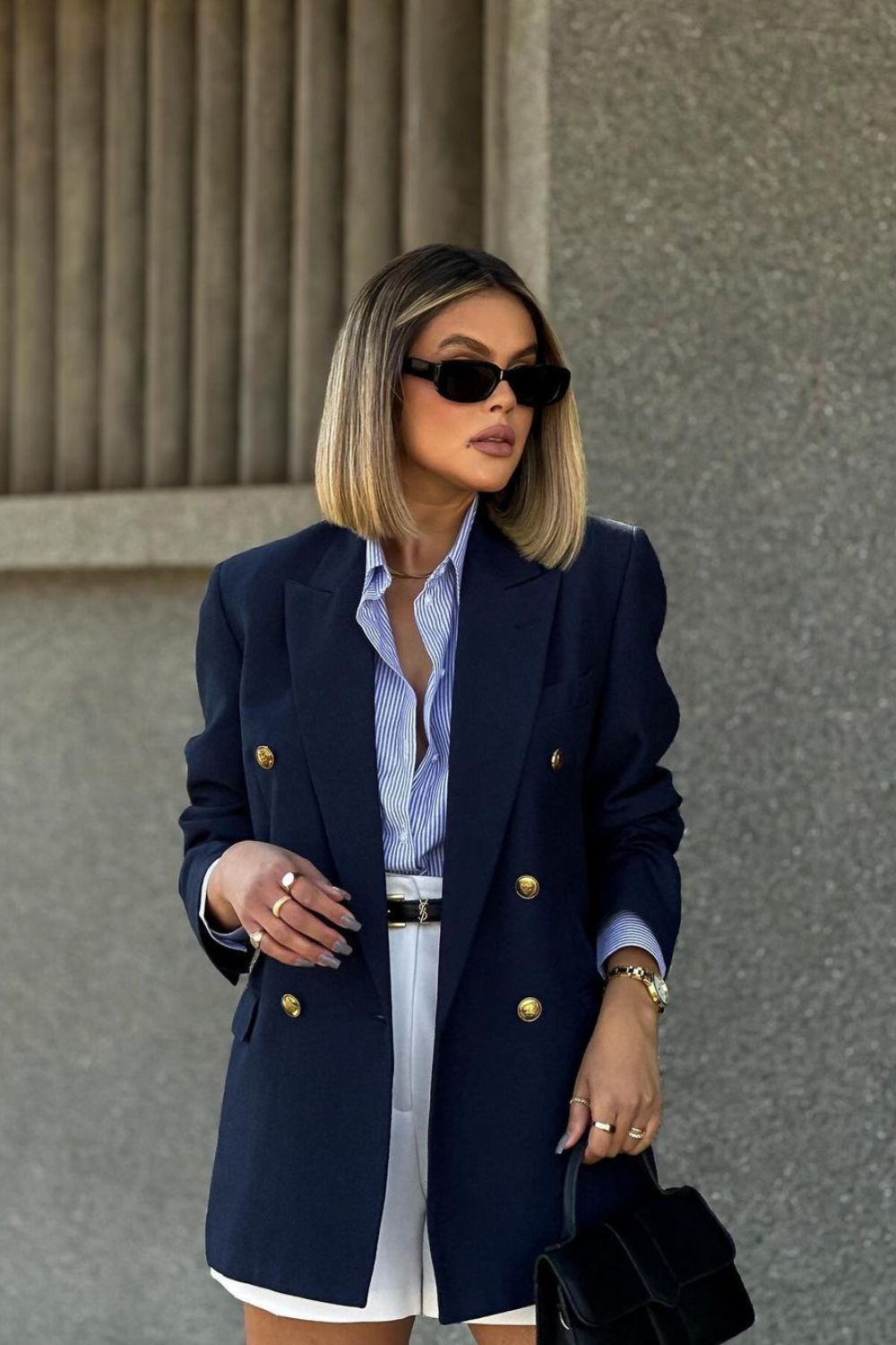 Woman in a blazer with metallic buttons