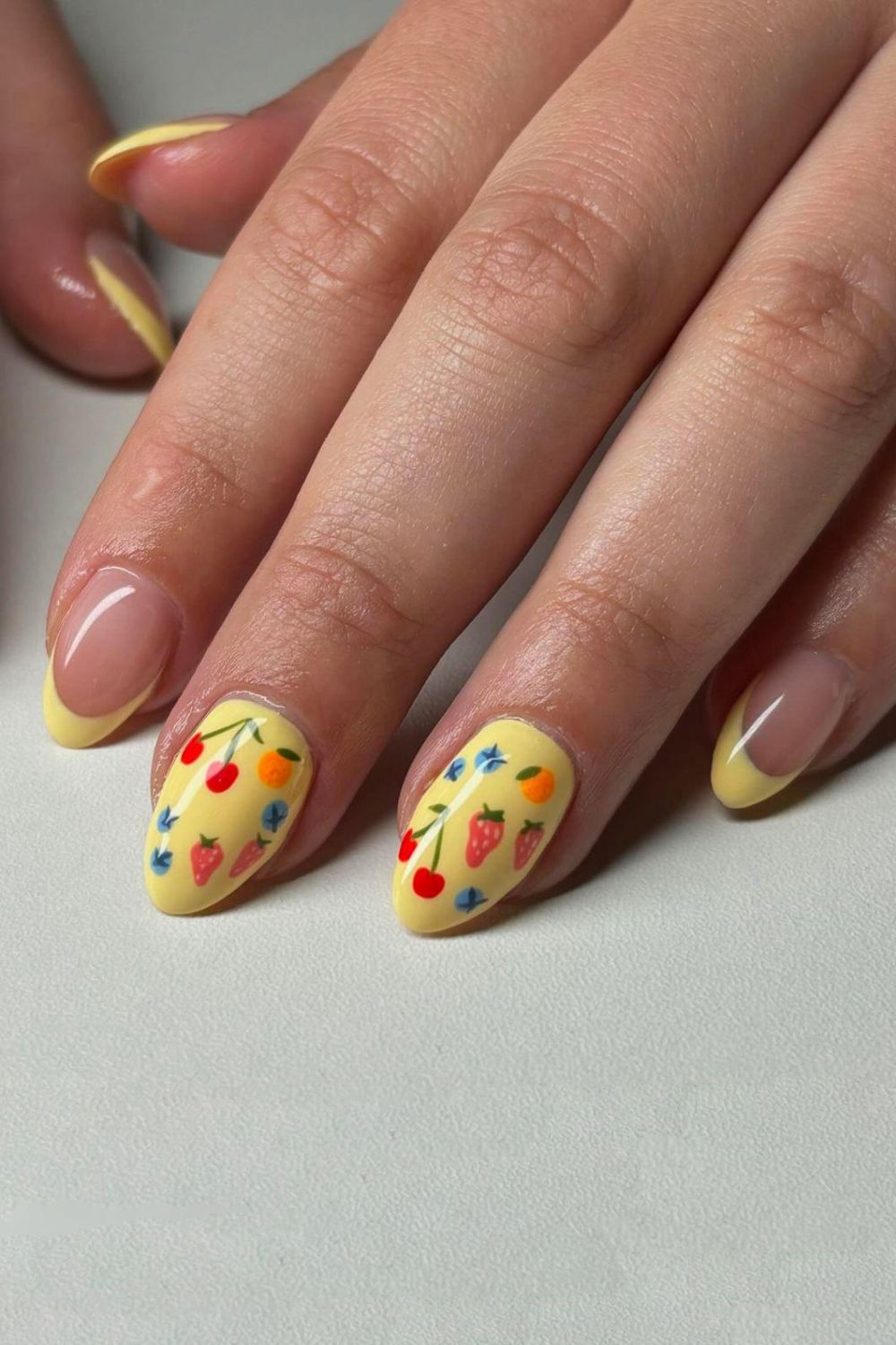 Yellow nails with a mix of fruity designs