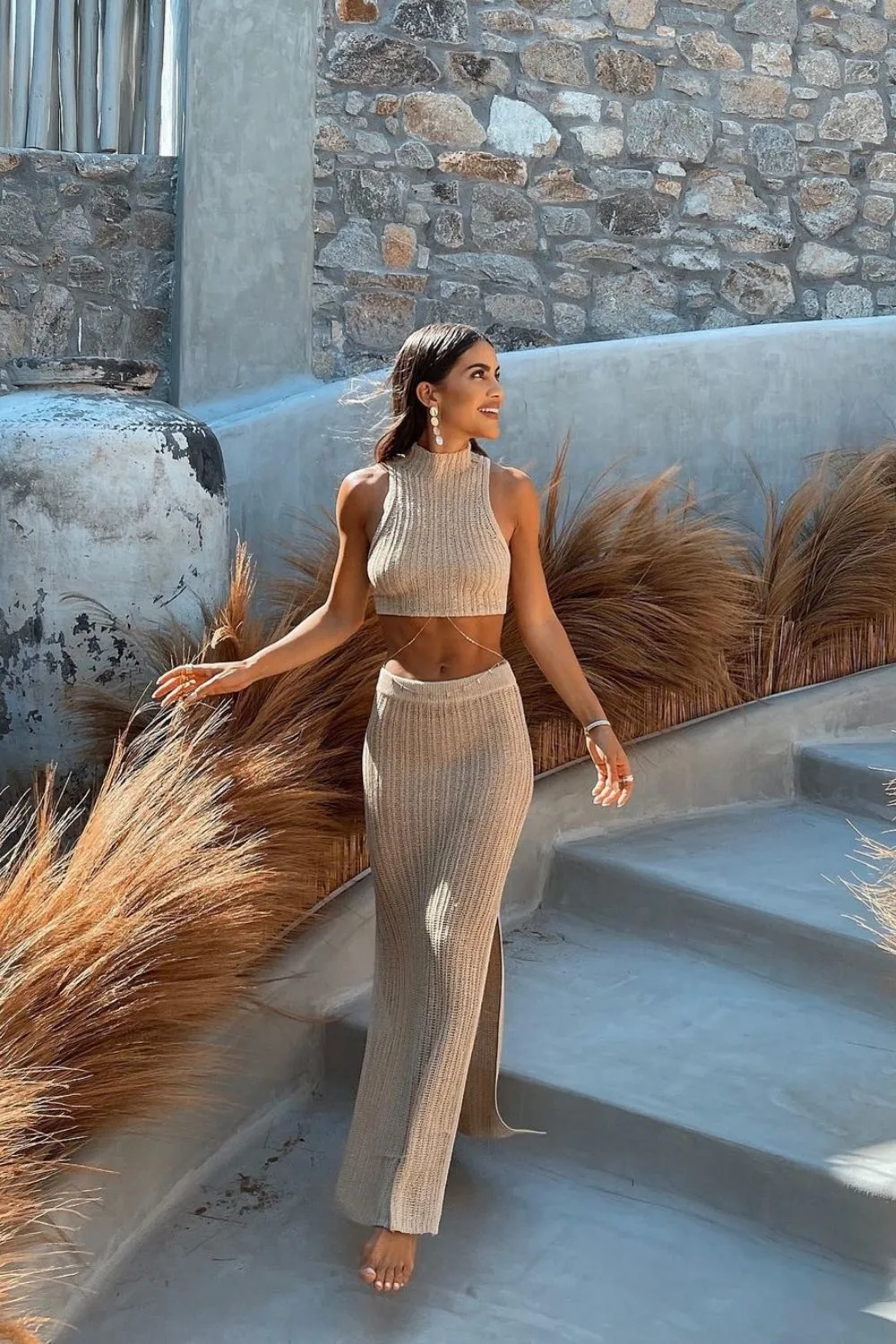 a model posing in a beige set on the stairs