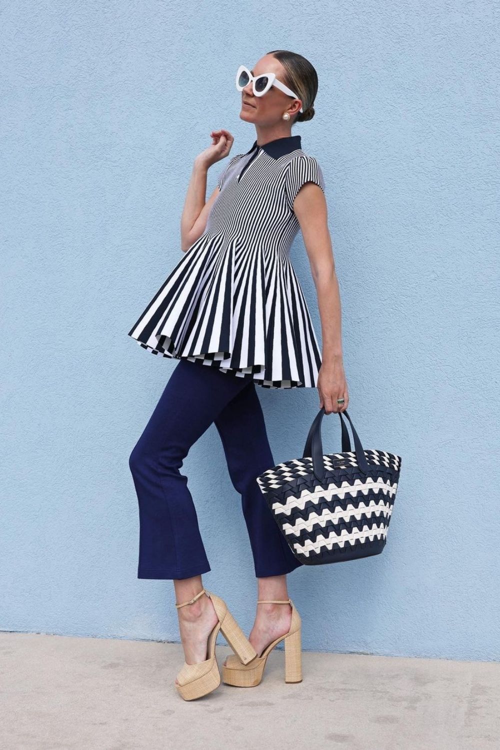 a modern woman wearing jeans and a blue and white stripe shirt