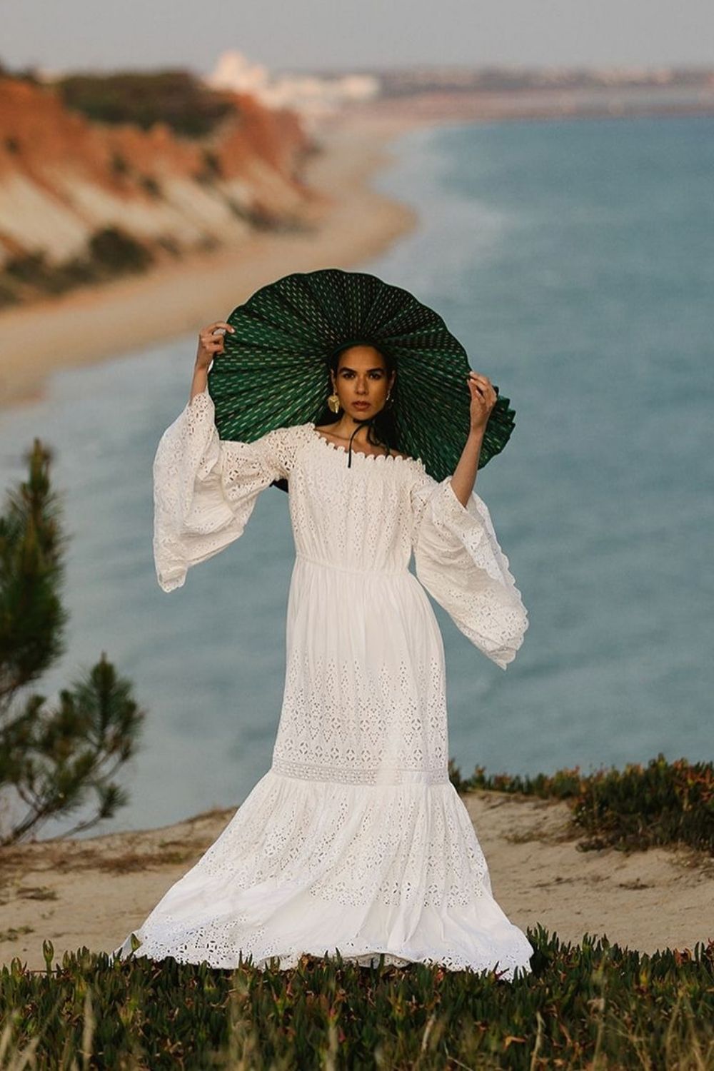 a woman in white maxi dress and a huge hat