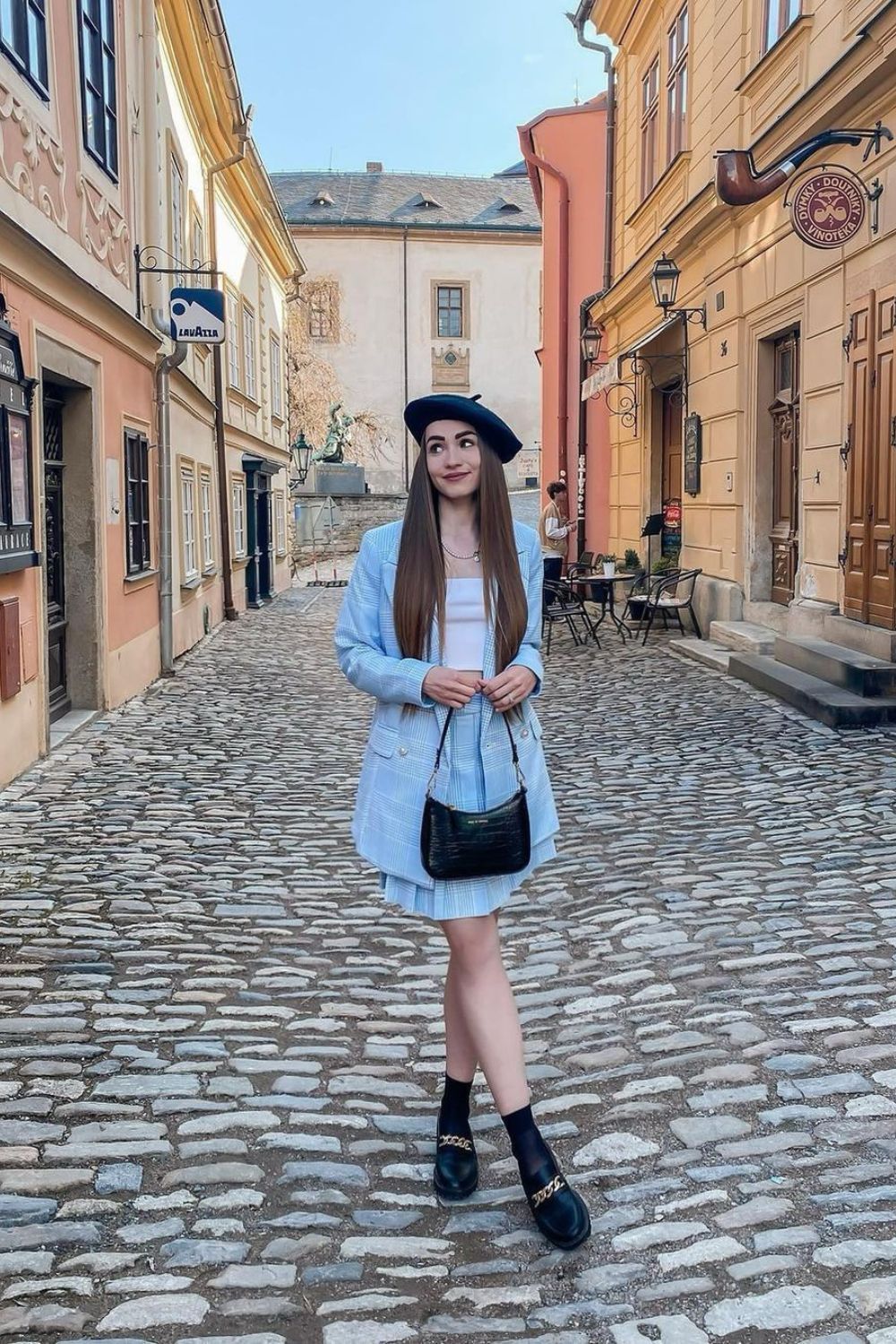 a woman posing with a parisian hat