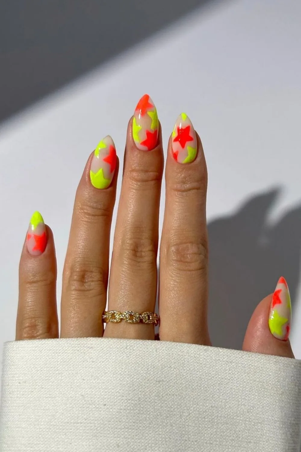 almond nails with yellow and orange stars