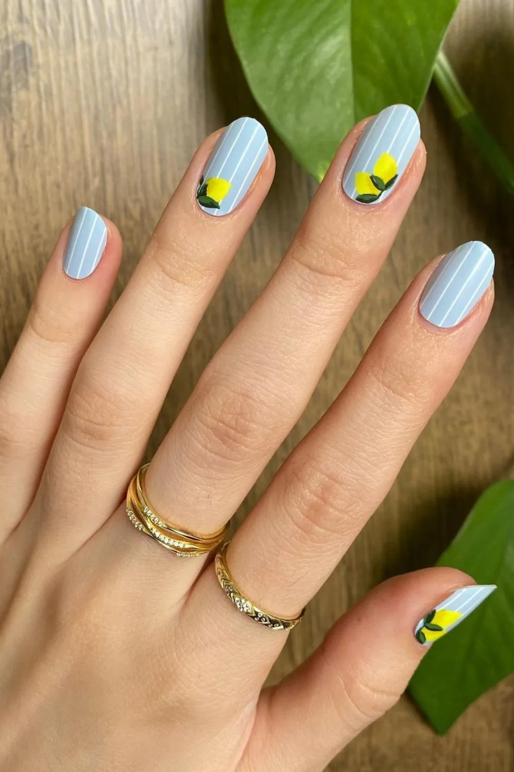 blue nails with stripes and lemons