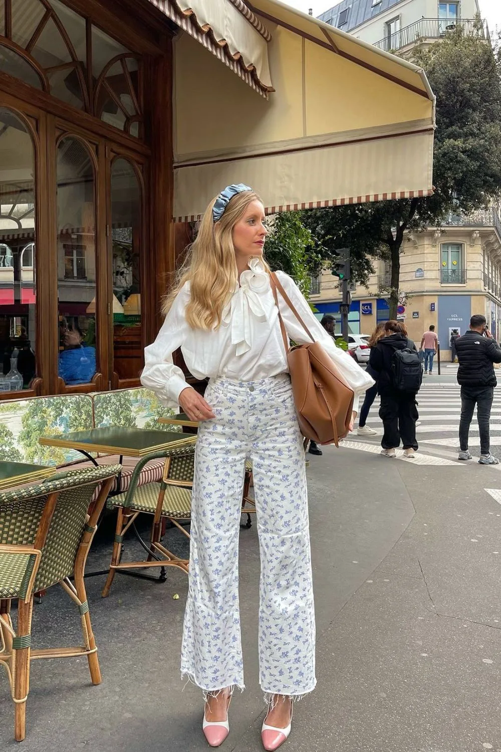 chic woman posing in a pants and white shirt