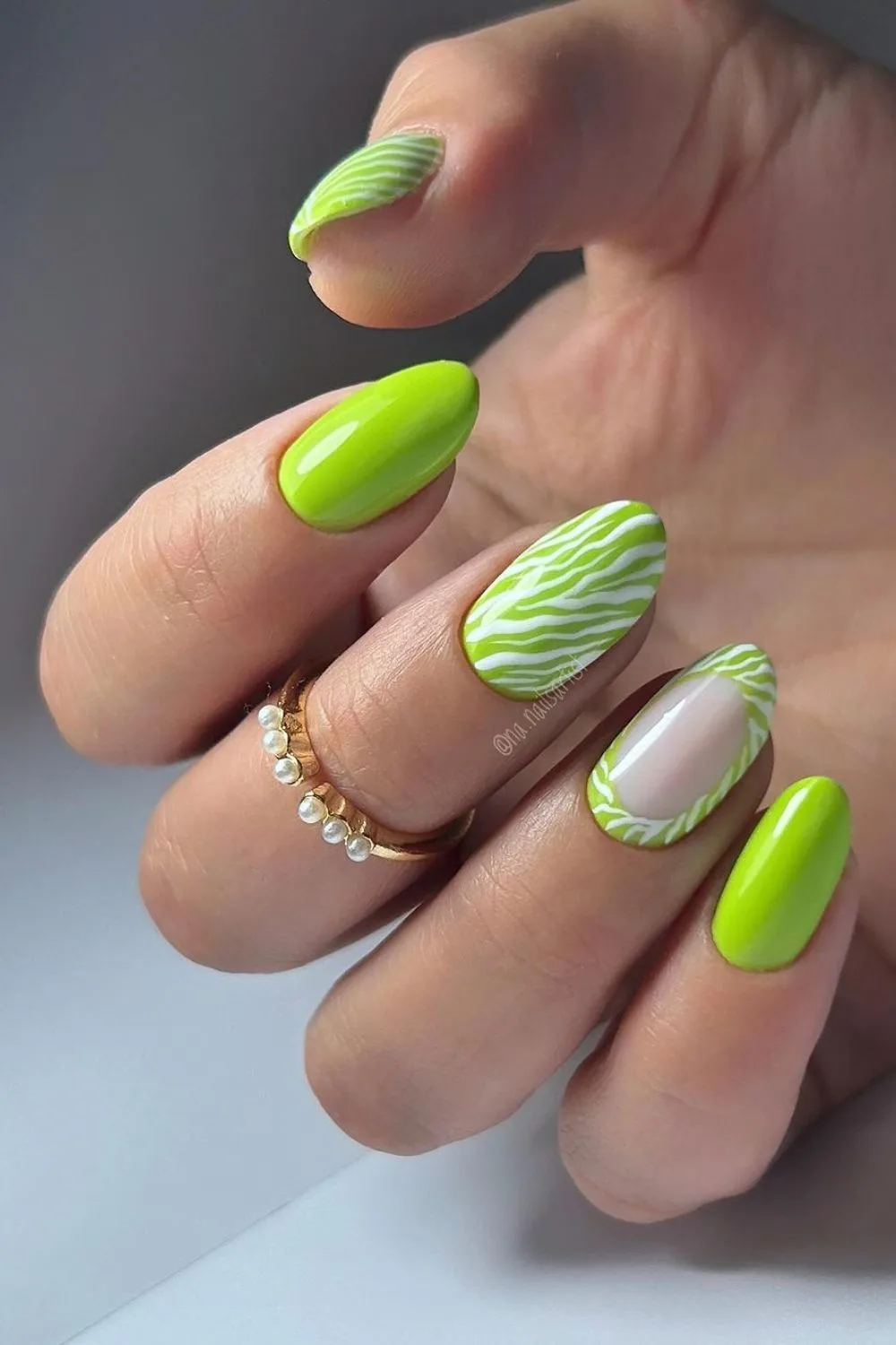 lime green nails with white zebra stripes
