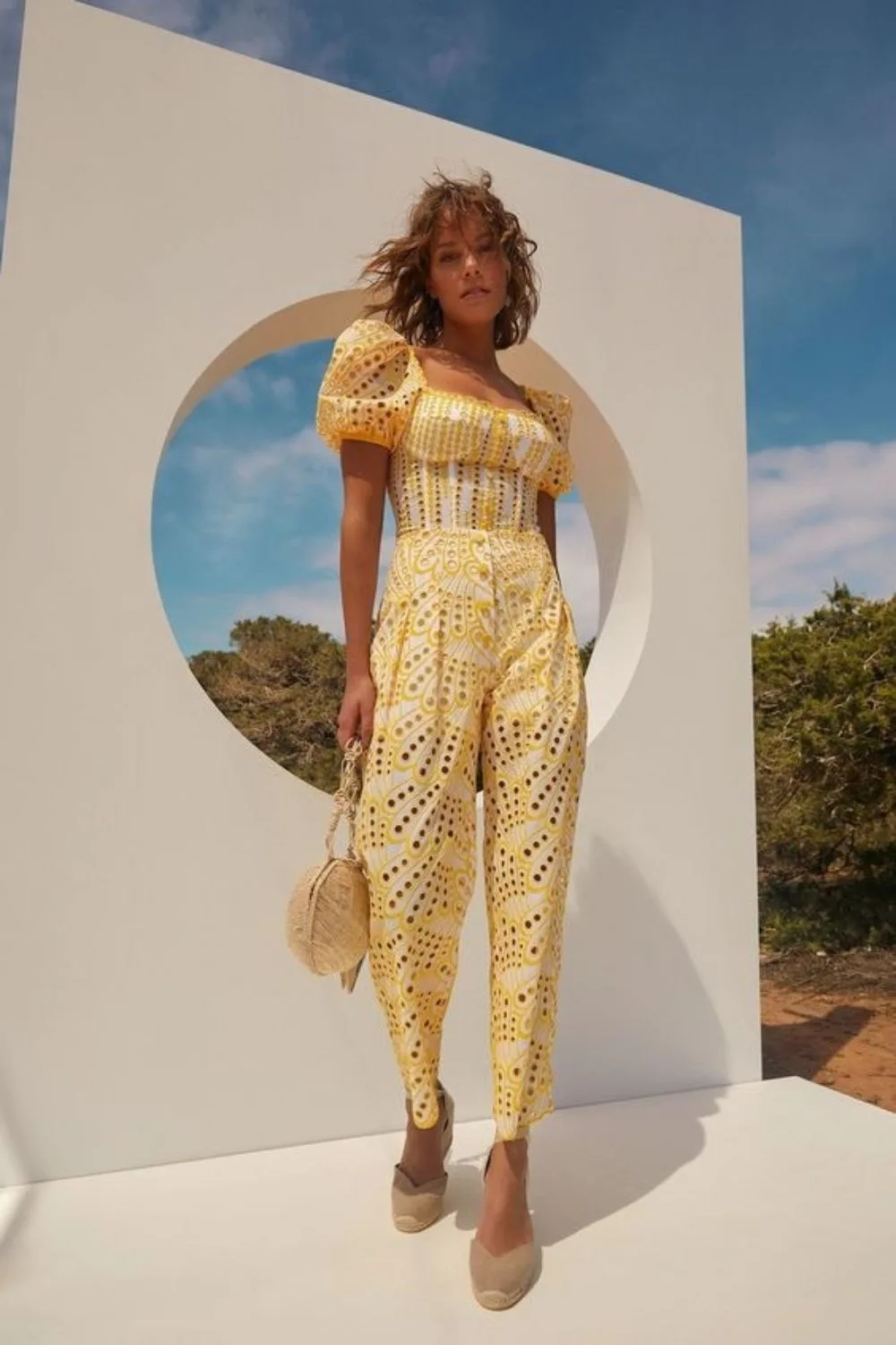 model posing in a yellow jumpsuit