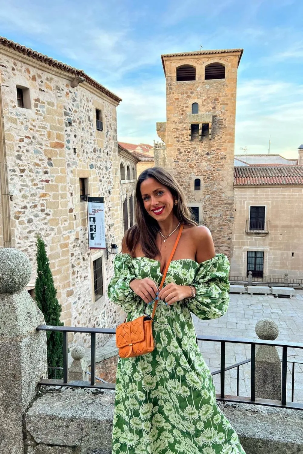 smiling woman in a green floral dress