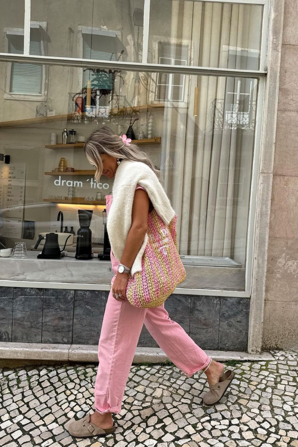 stylish woman in a pink pants and a bag