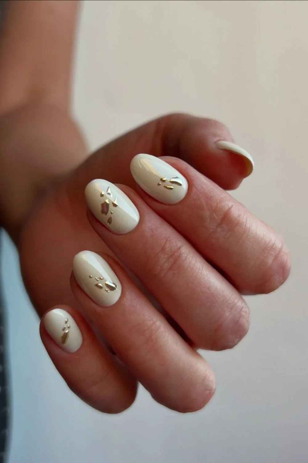 white chrome nails with a splash of gold