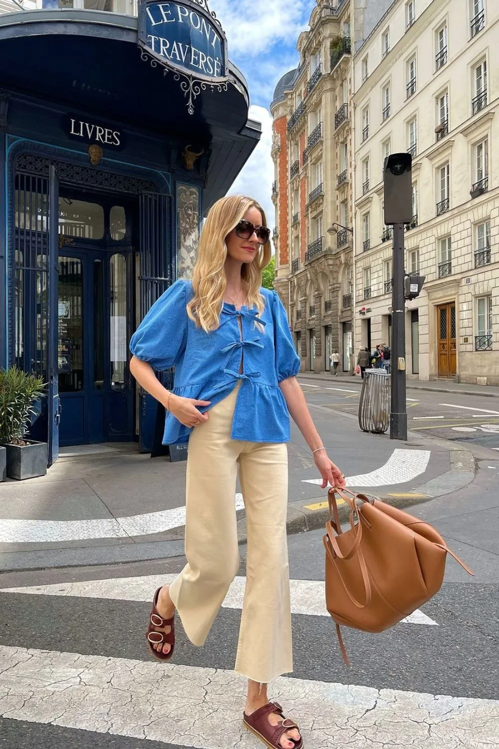 woman in blue shirt walking on the street