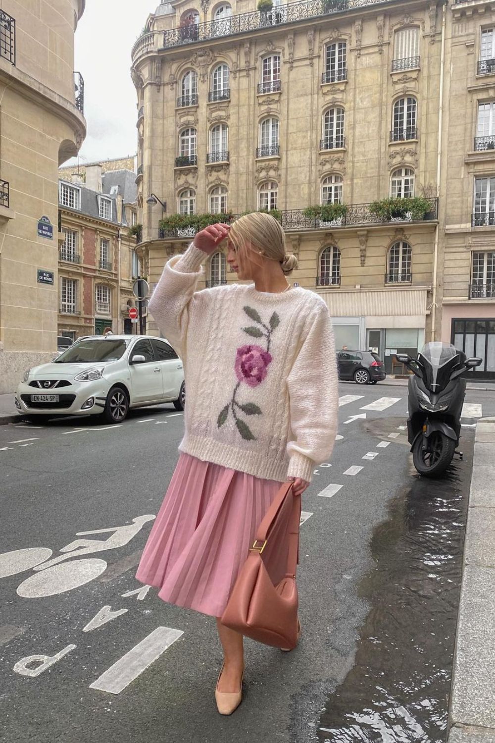 woman in pink skirt covered with oversized sweater