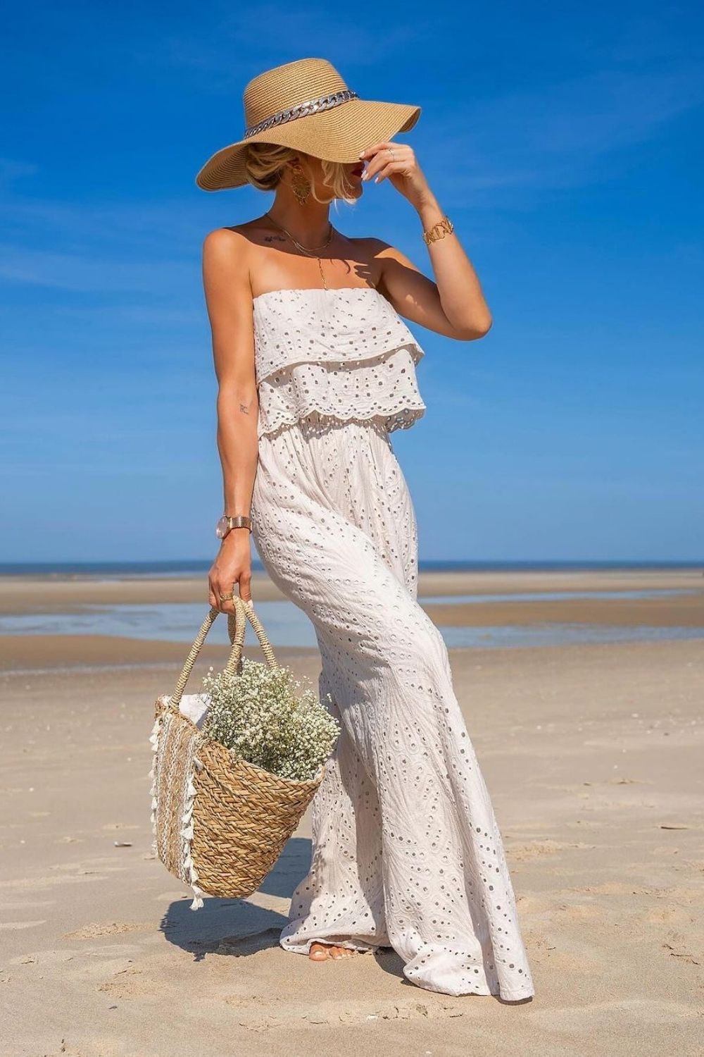 woman in white jumpsuit and a hat