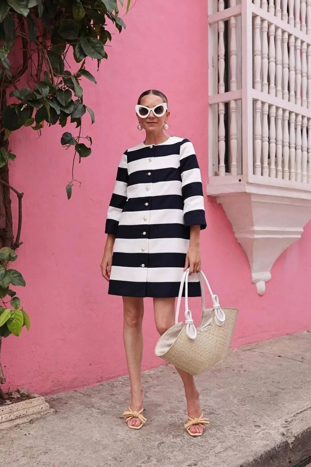 woman posing in a black and white dress