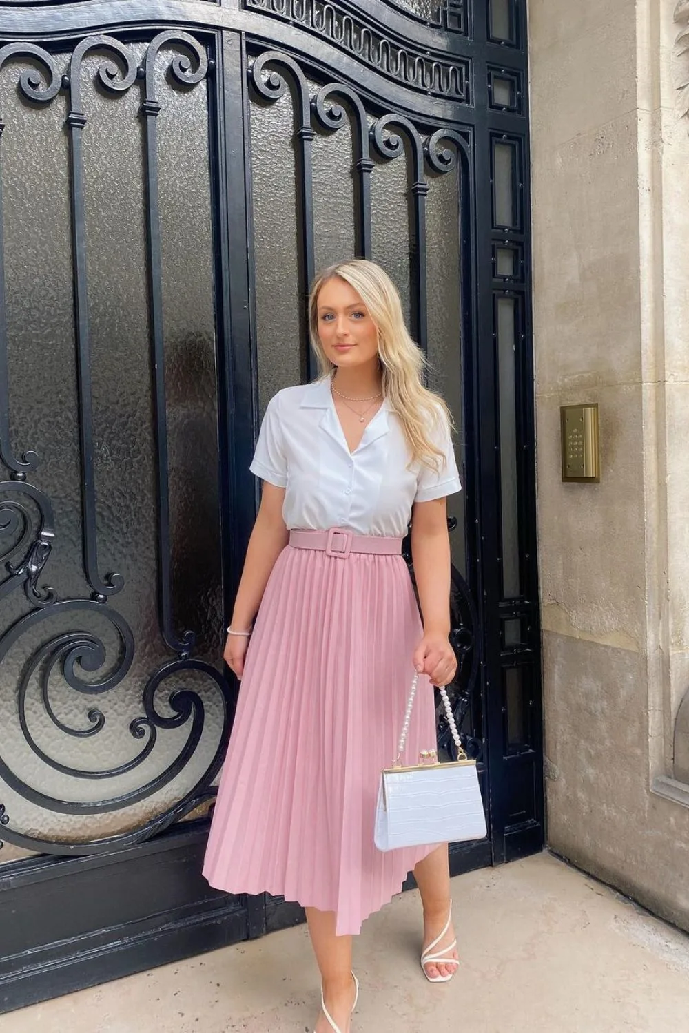 woman posing in a soft pink skirt and a shirt