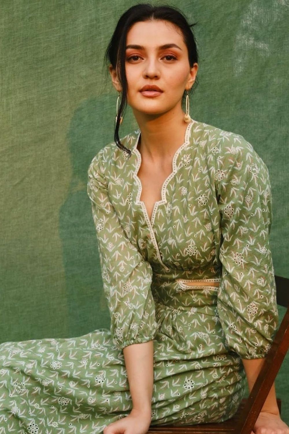 woman posing in olive patterned dress