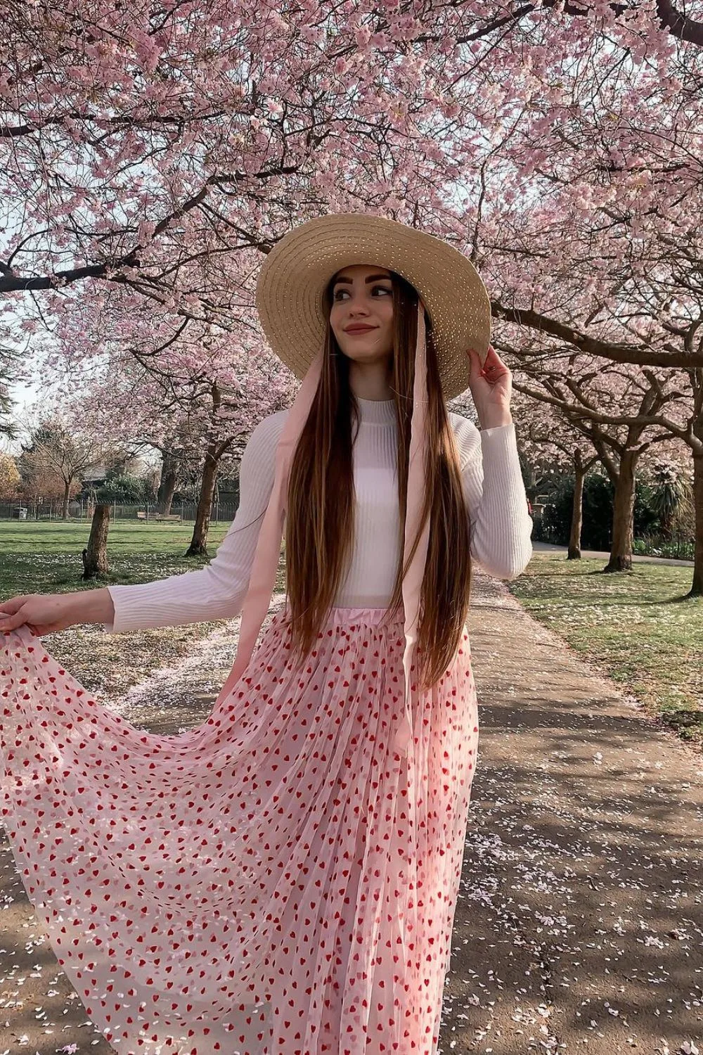 woman posing in a heart skirt and a hat