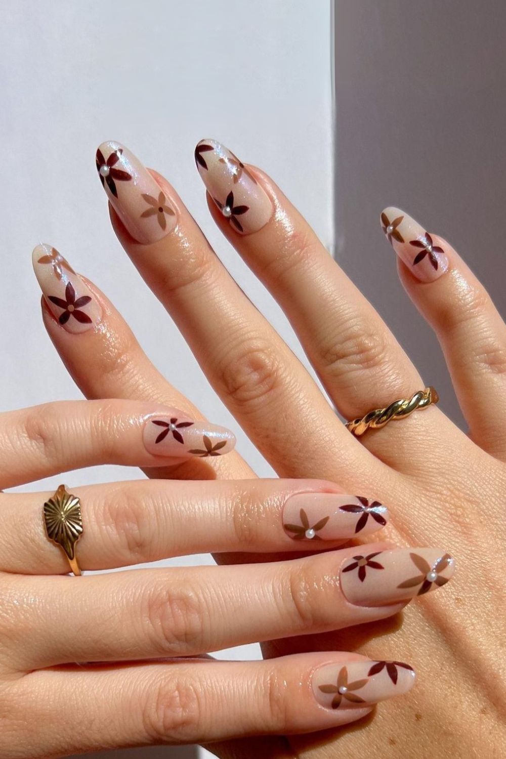 Almond-colored nails with brown flowers