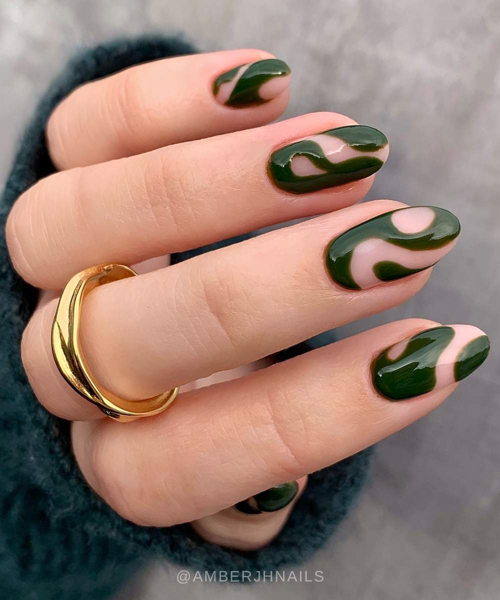 Almond nails with dark green abstract swirls